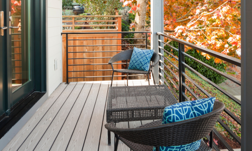 An outdoor deck with brown boards and black aluminum railings.