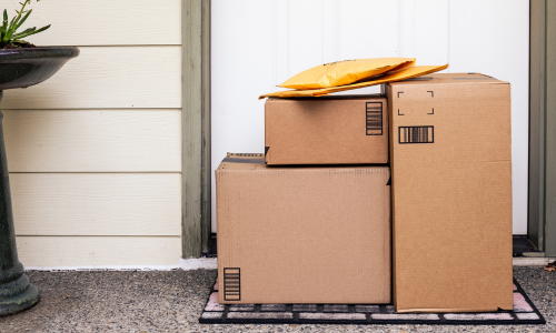 Cardboard boxes stacked at a doorstep.